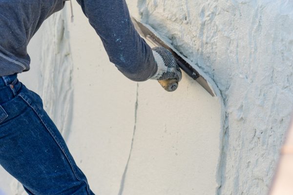 Worker Smoothing Wet Pool Plaster With Trowel.